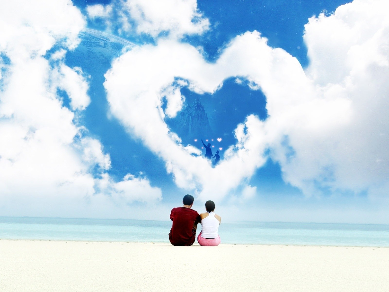 Couple on beach with heart cloud