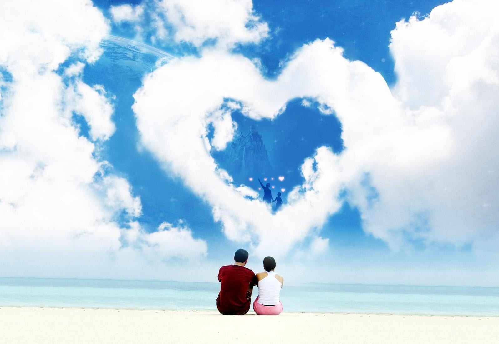 Couple on beach with heart cloud