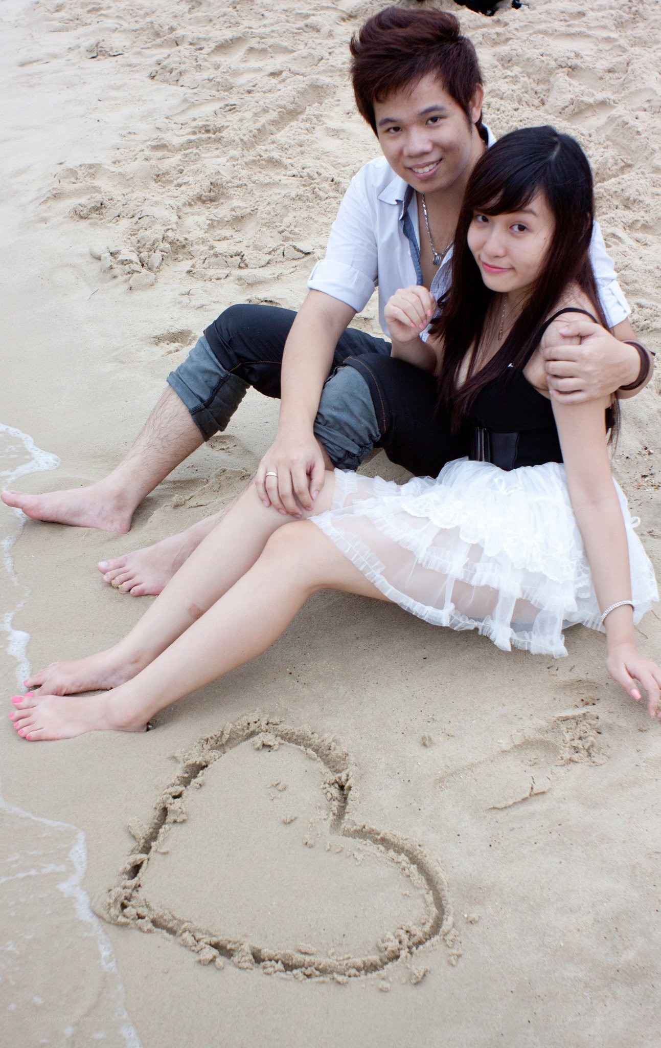 Couple on beach with heart