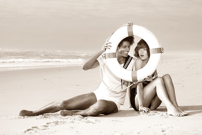Couple on Beach with Life Preserver