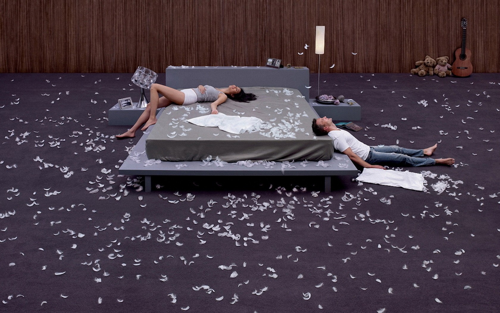 Couple on bed with feathers