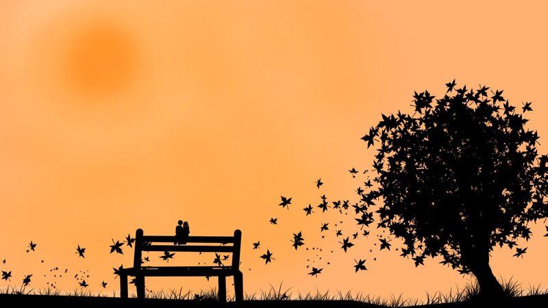 Couple on bench at sunset