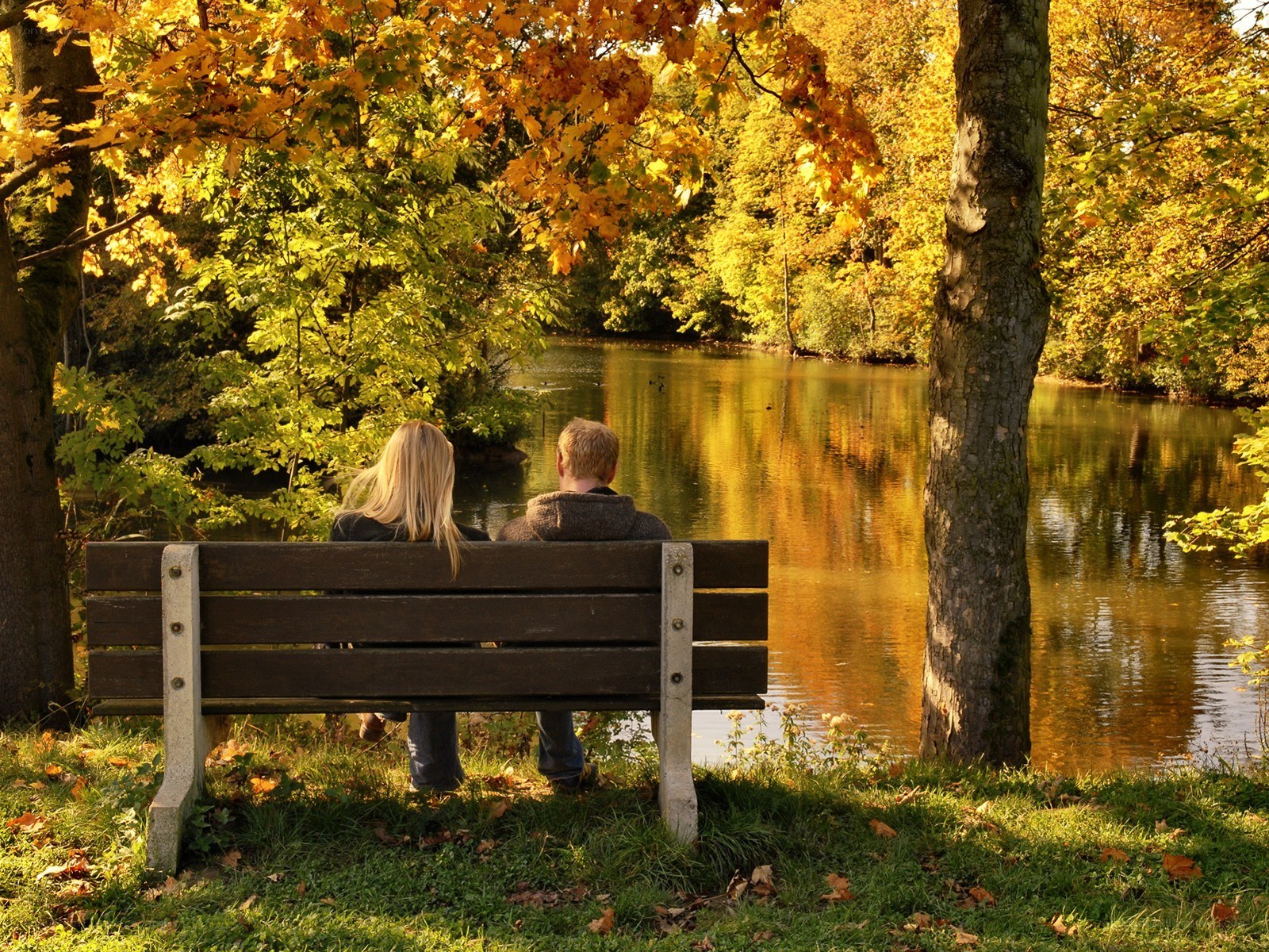 Couple on bench by lake