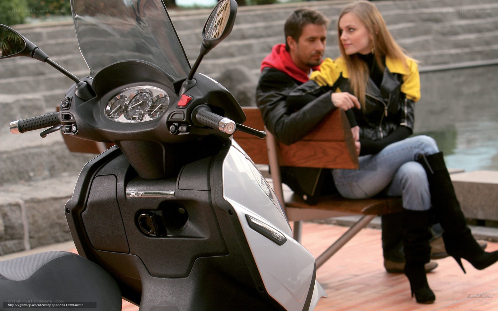 Couple on bench with scooter