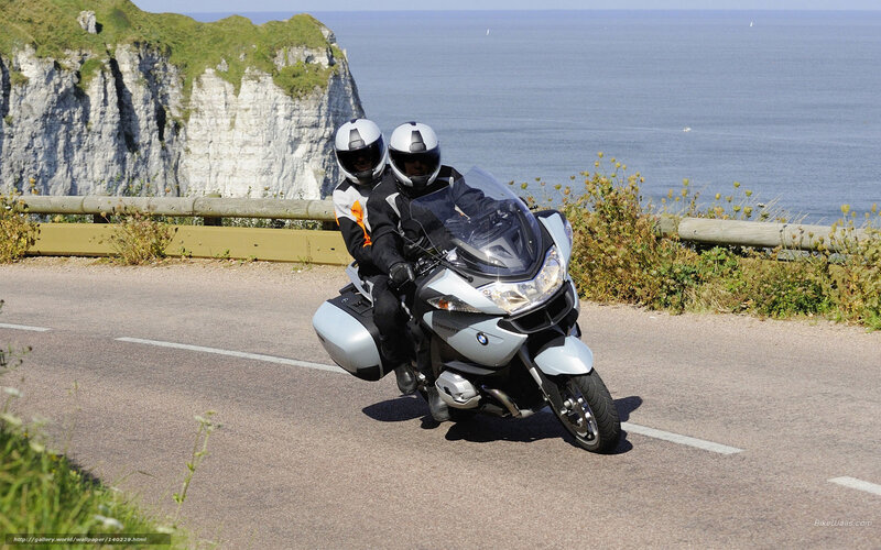 Couple on motorcycle by the sea