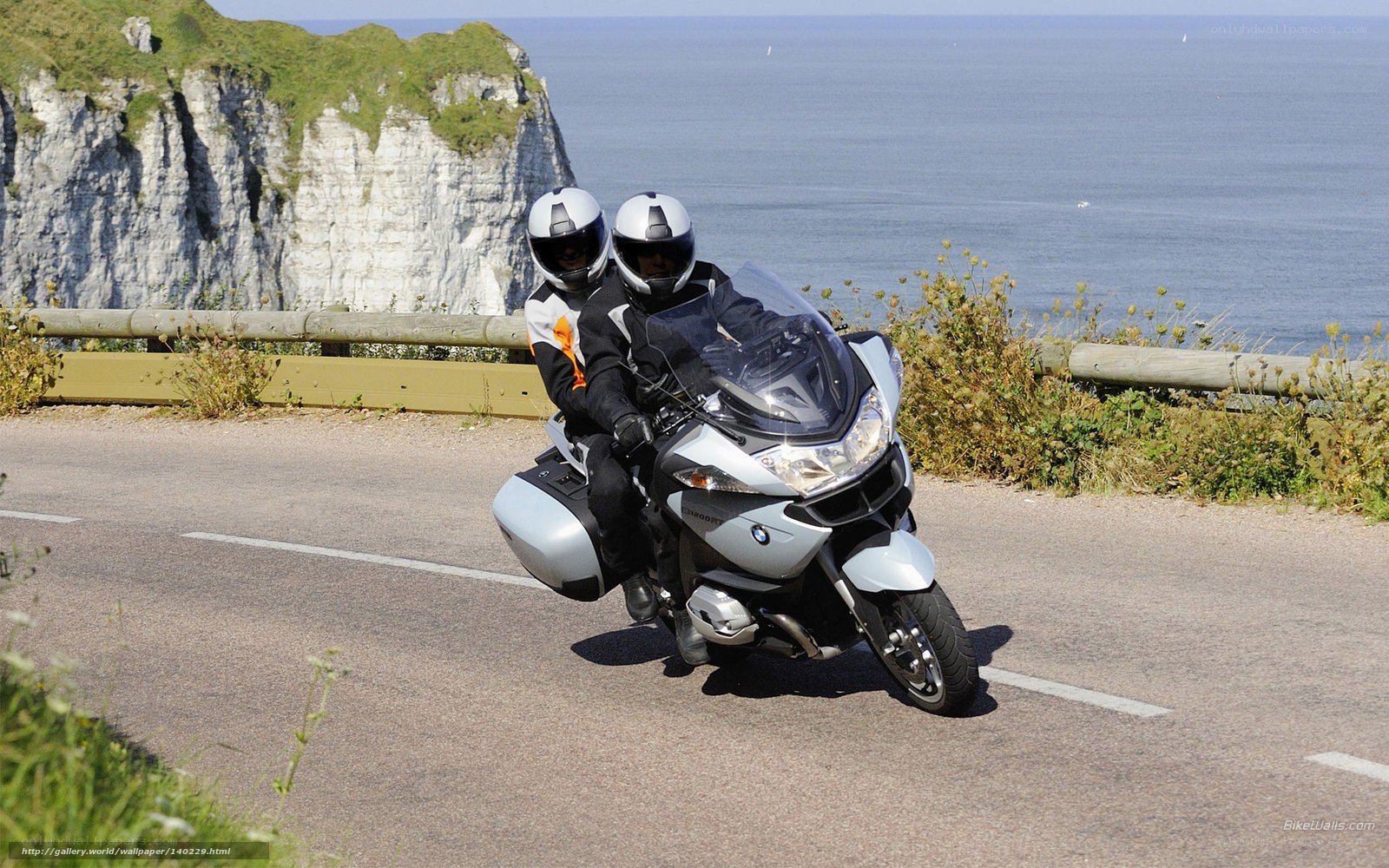Couple on motorcycle by the sea