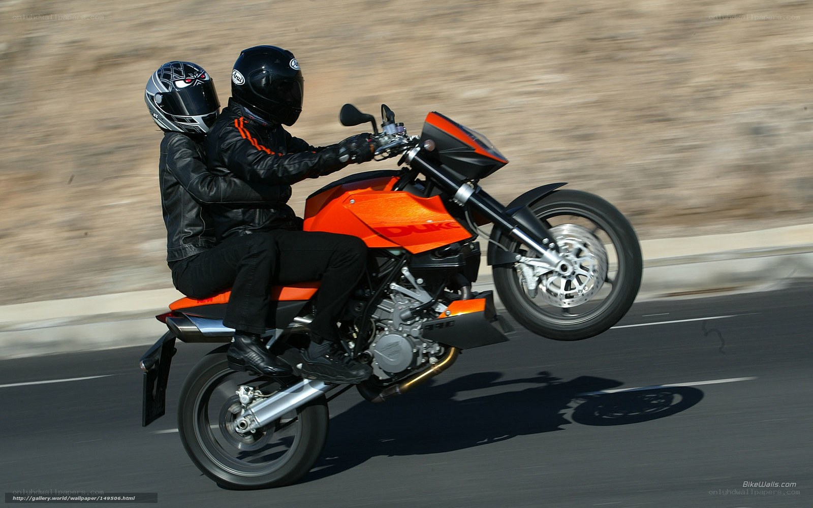 Couple on orange motorcycle