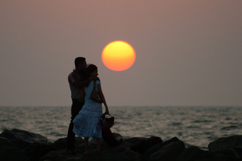 Couple on Rocky Shore — Orange