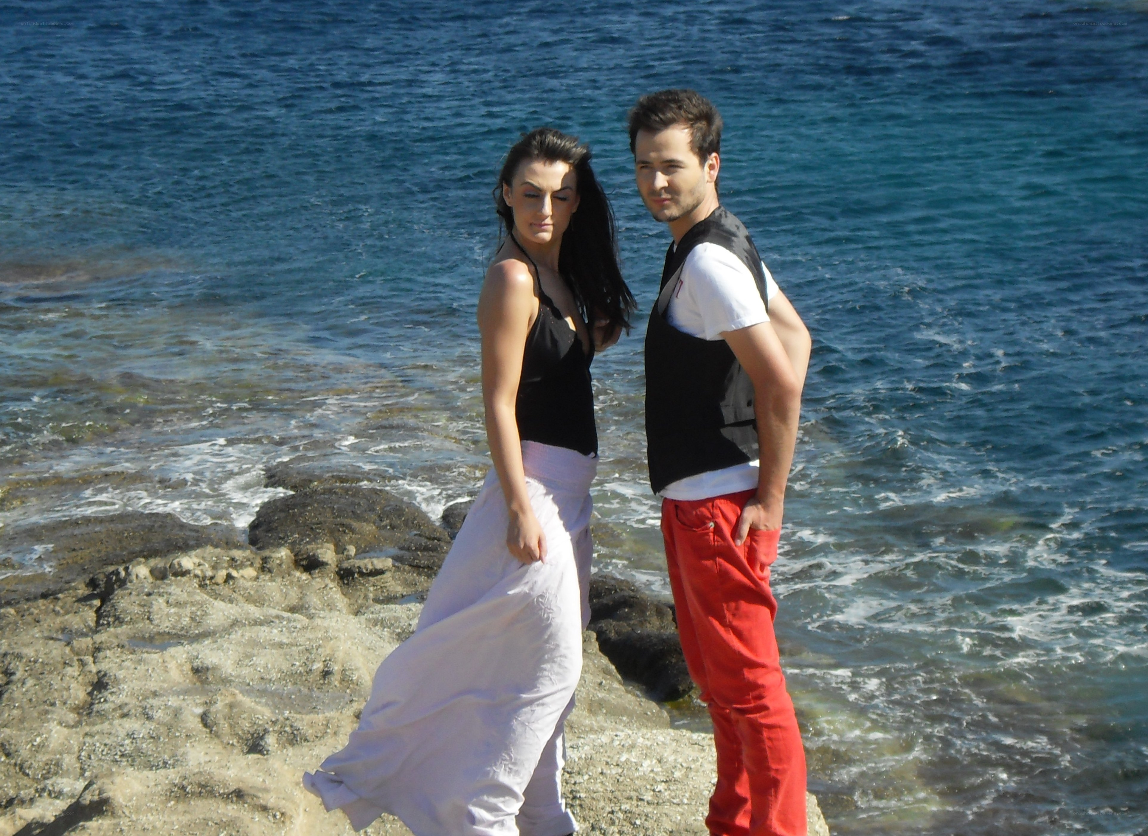Couple on rocky shore
