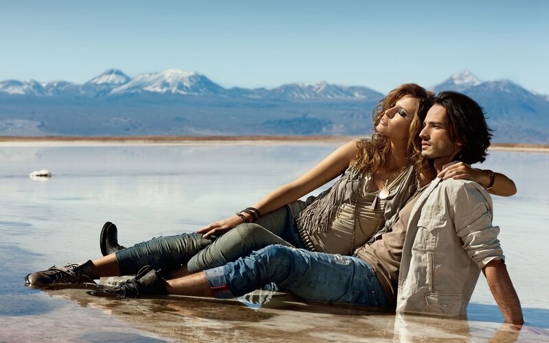 Couple on salt flats with mountains