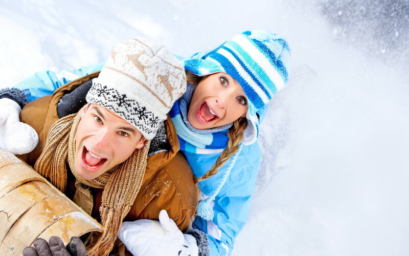 Couple on Sled in Snow