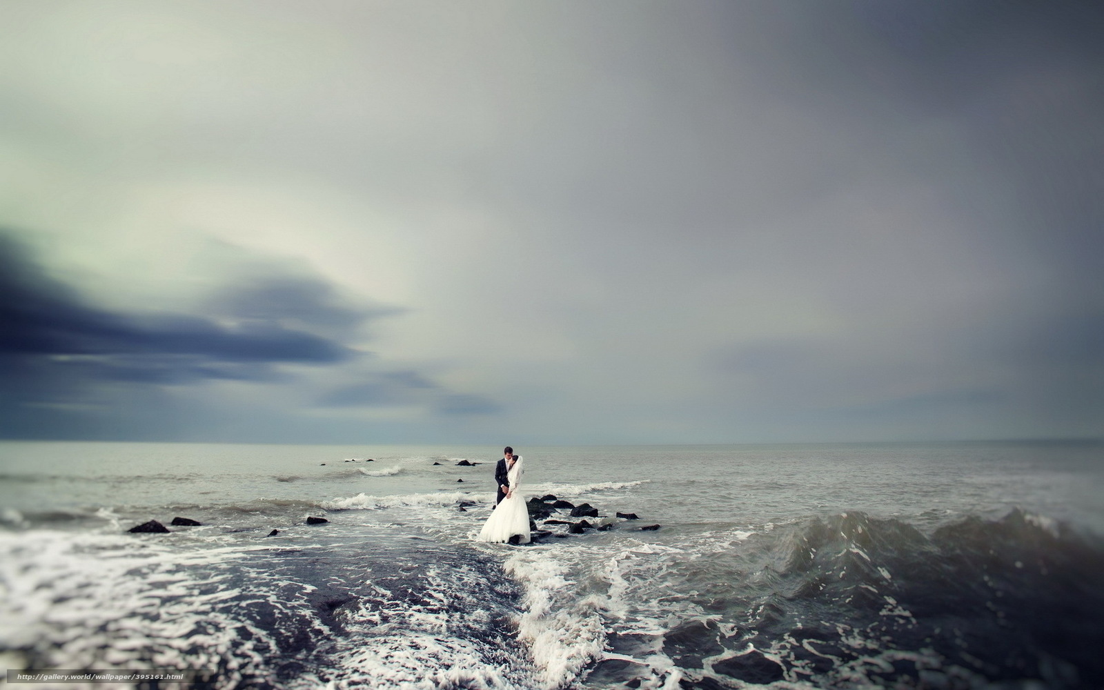 Couple on stormy beach