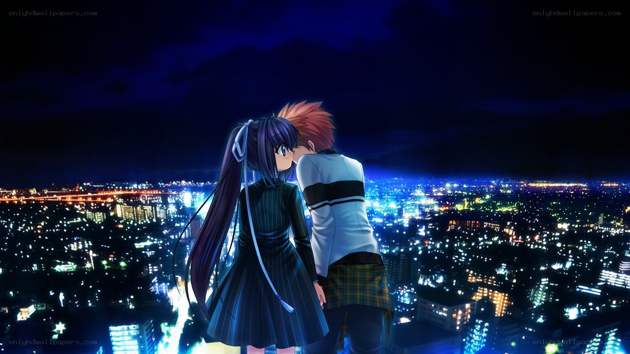 couple overlooking city at night