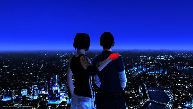 couple overlooking city at night
