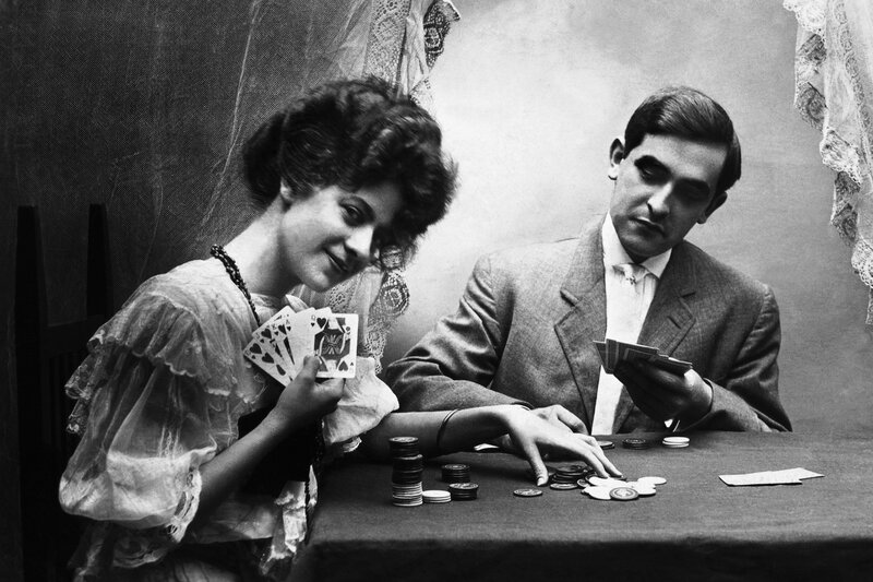 Couple playing cards at table