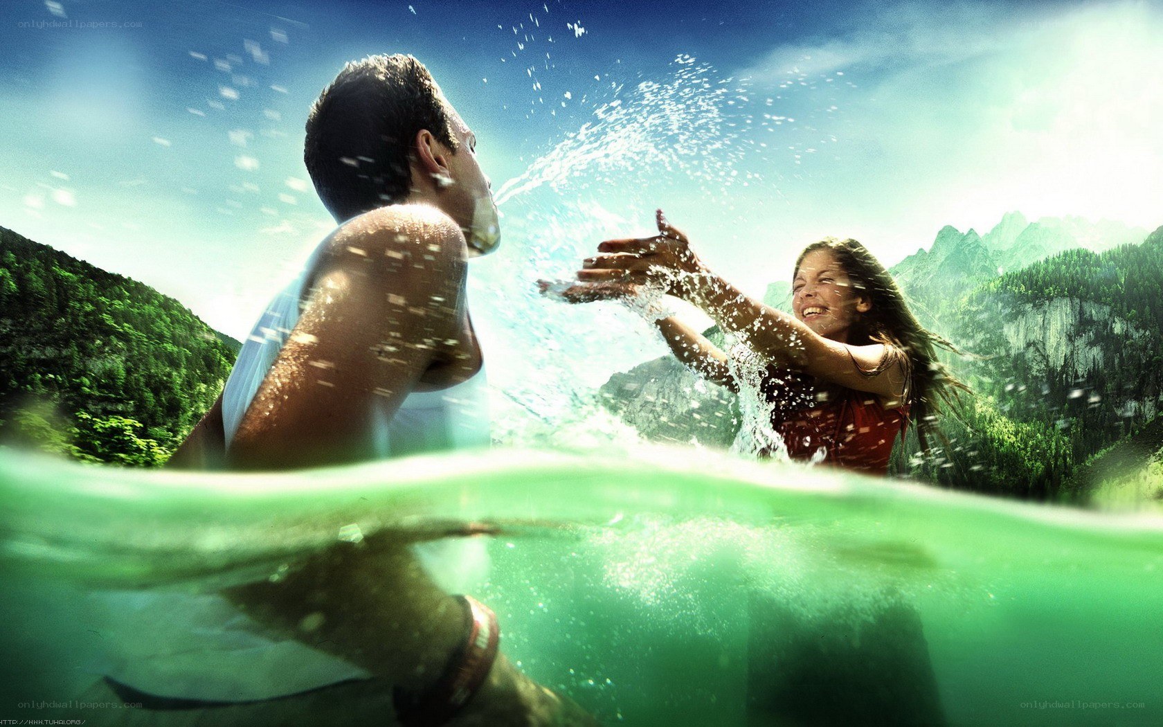 Couple playing in mountain lake
