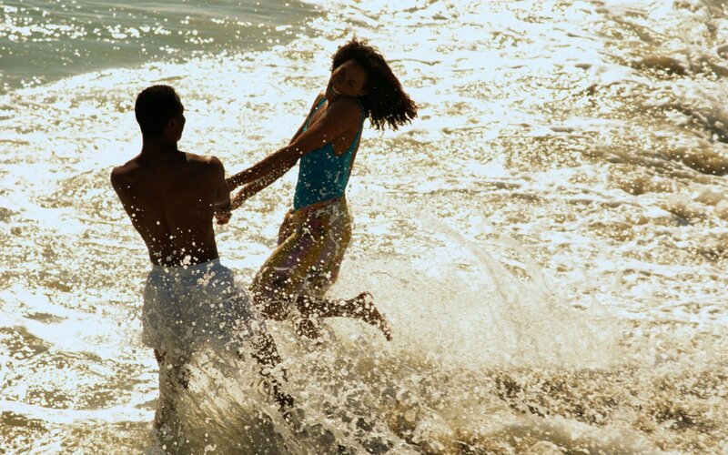 Couple Playing in Waves