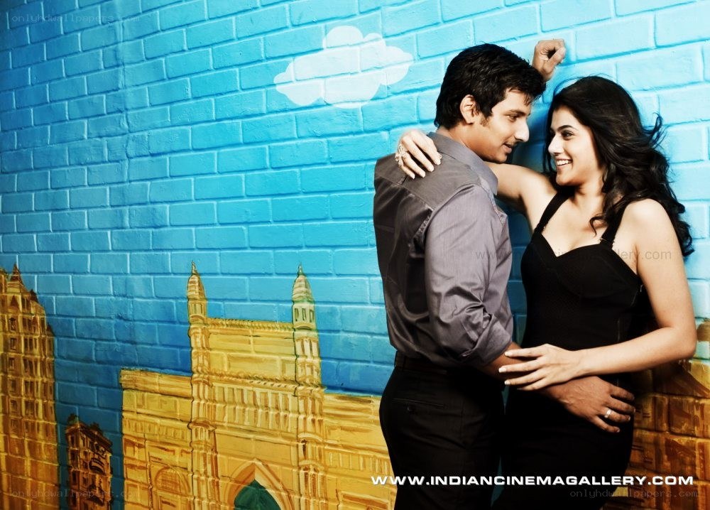 Couple posing in front of painted wall
