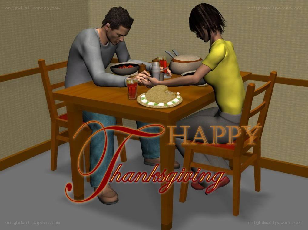 Couple praying before Thanksgiving meal