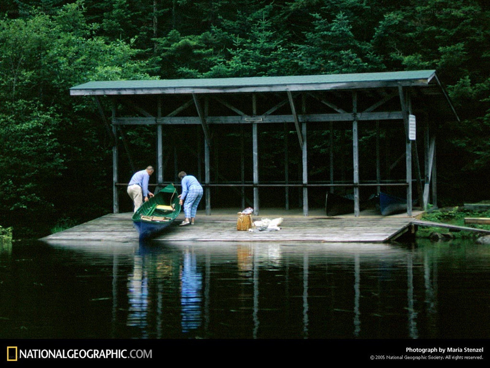 Couple preparing canoe at dock