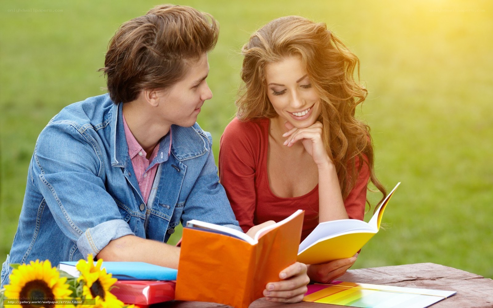 Couple reading books outdoors