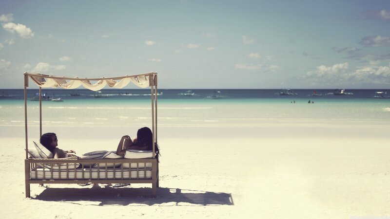 Couple relaxing on beach bed