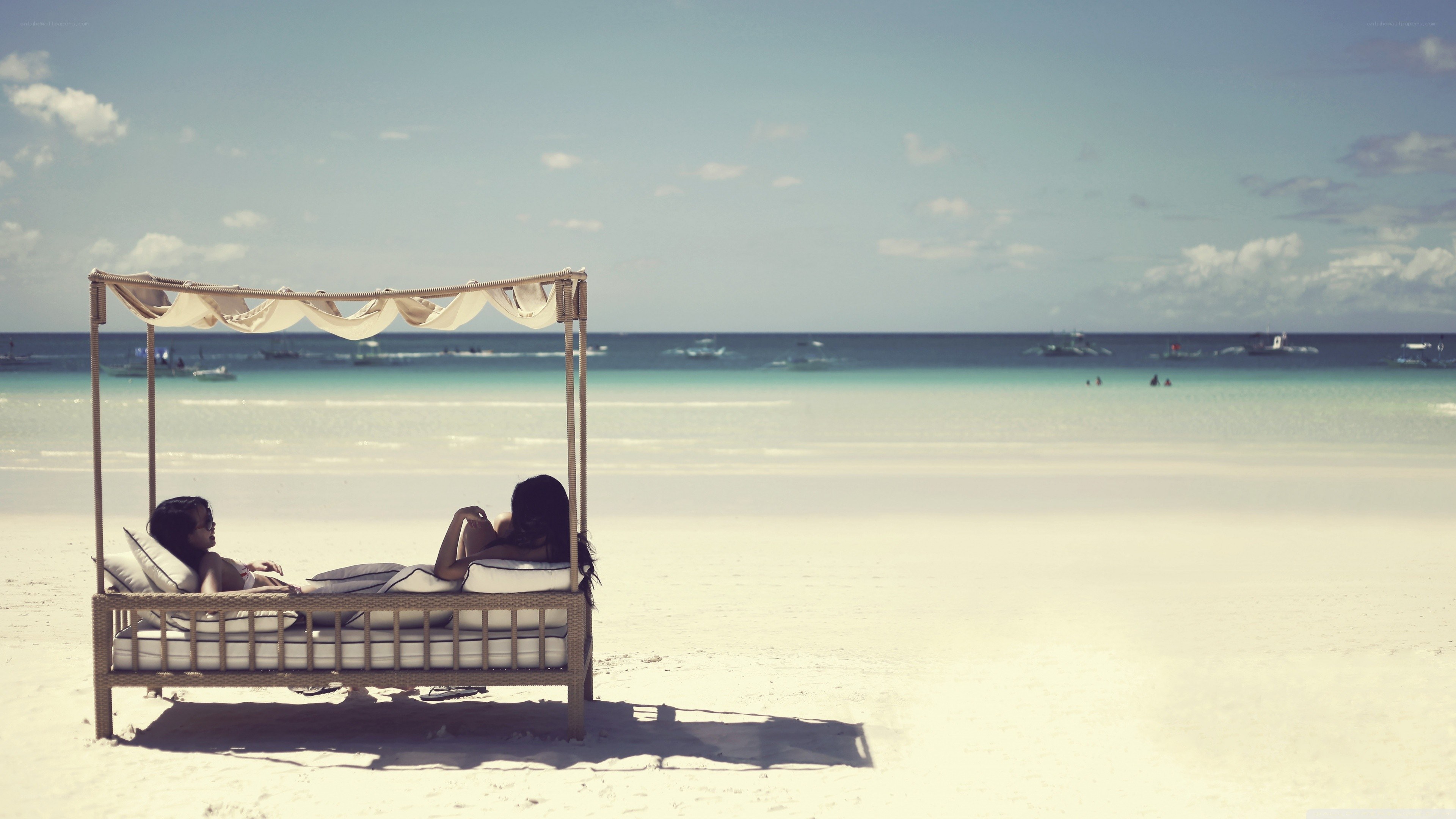 Couple relaxing on beach bed