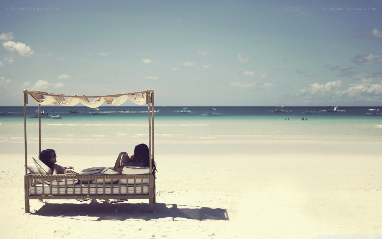 Couple relaxing on beach bed