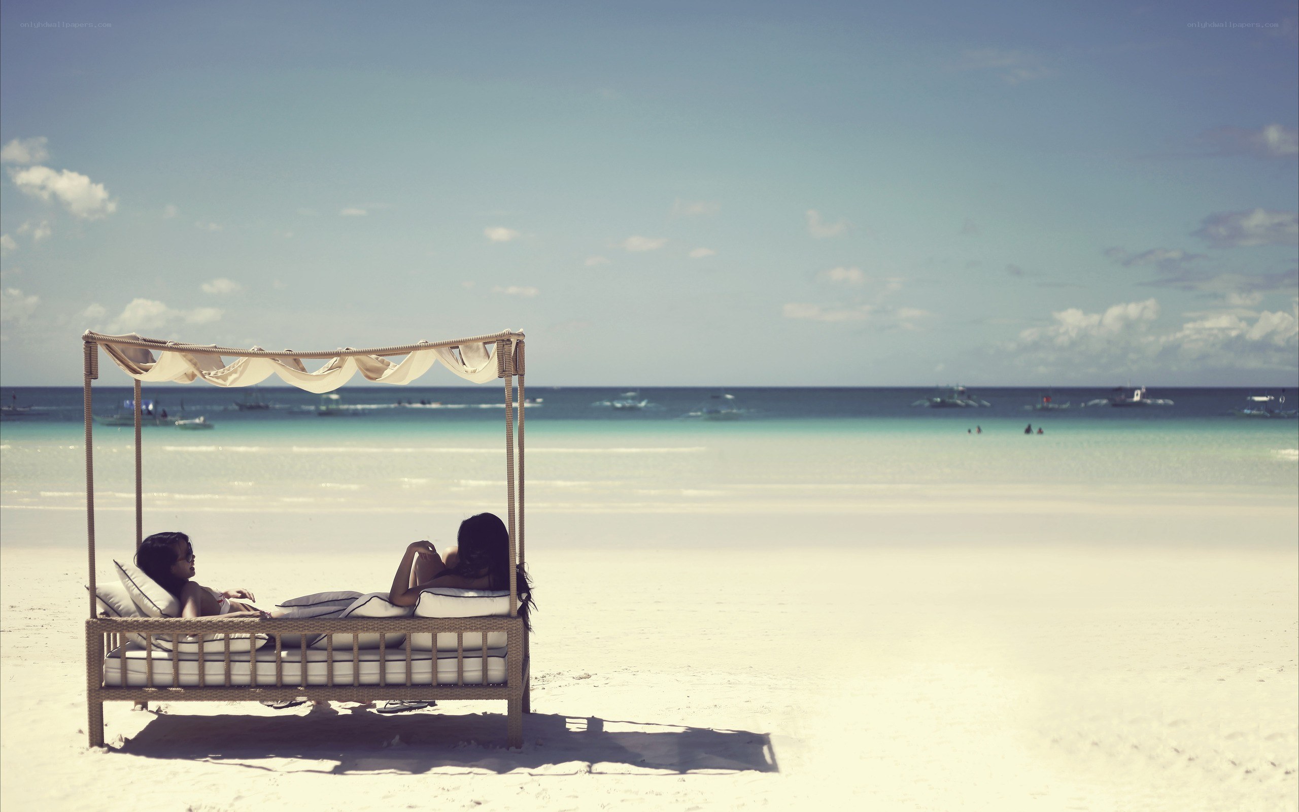 Couple relaxing on beach bed