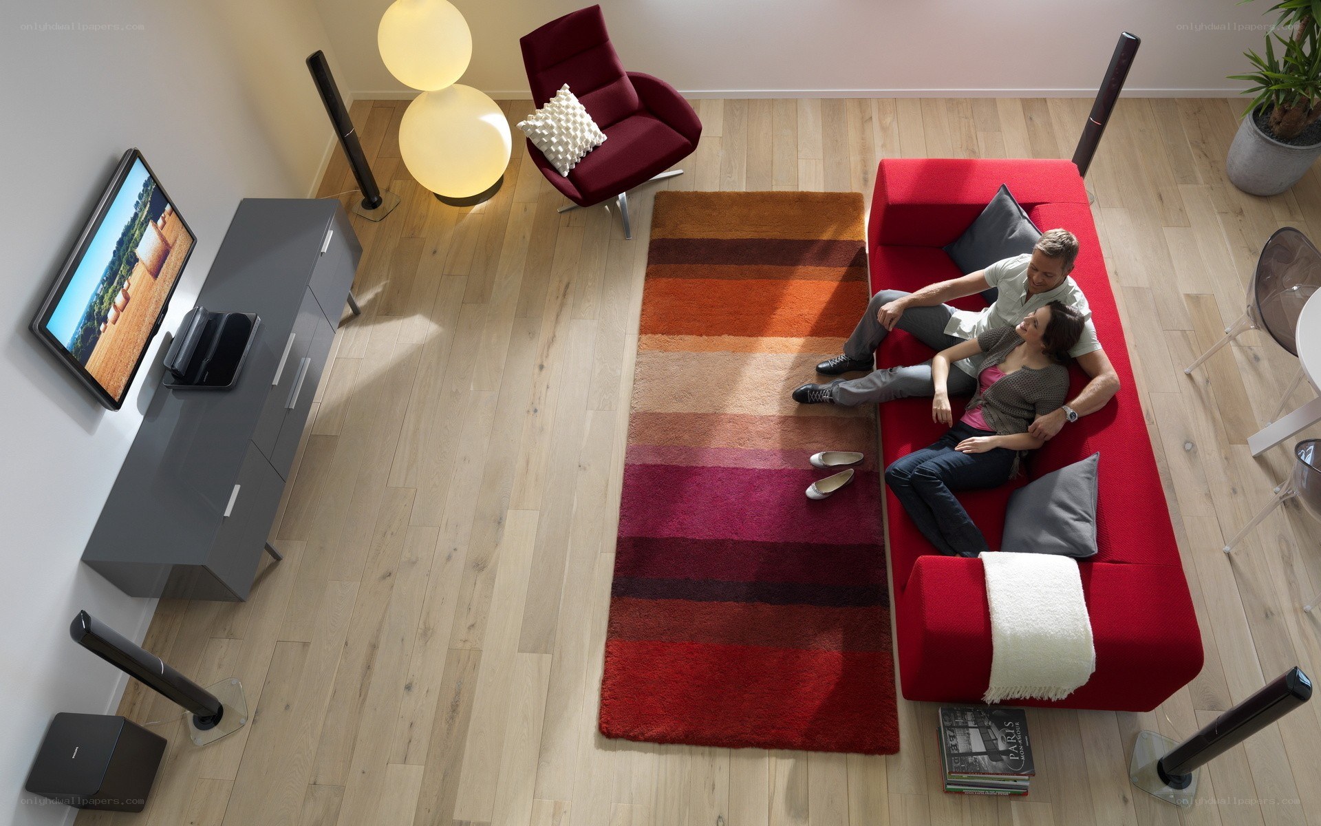 Couple relaxing on red sofa