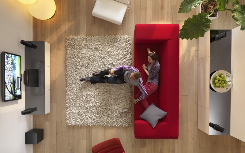 Couple relaxing on red sofa