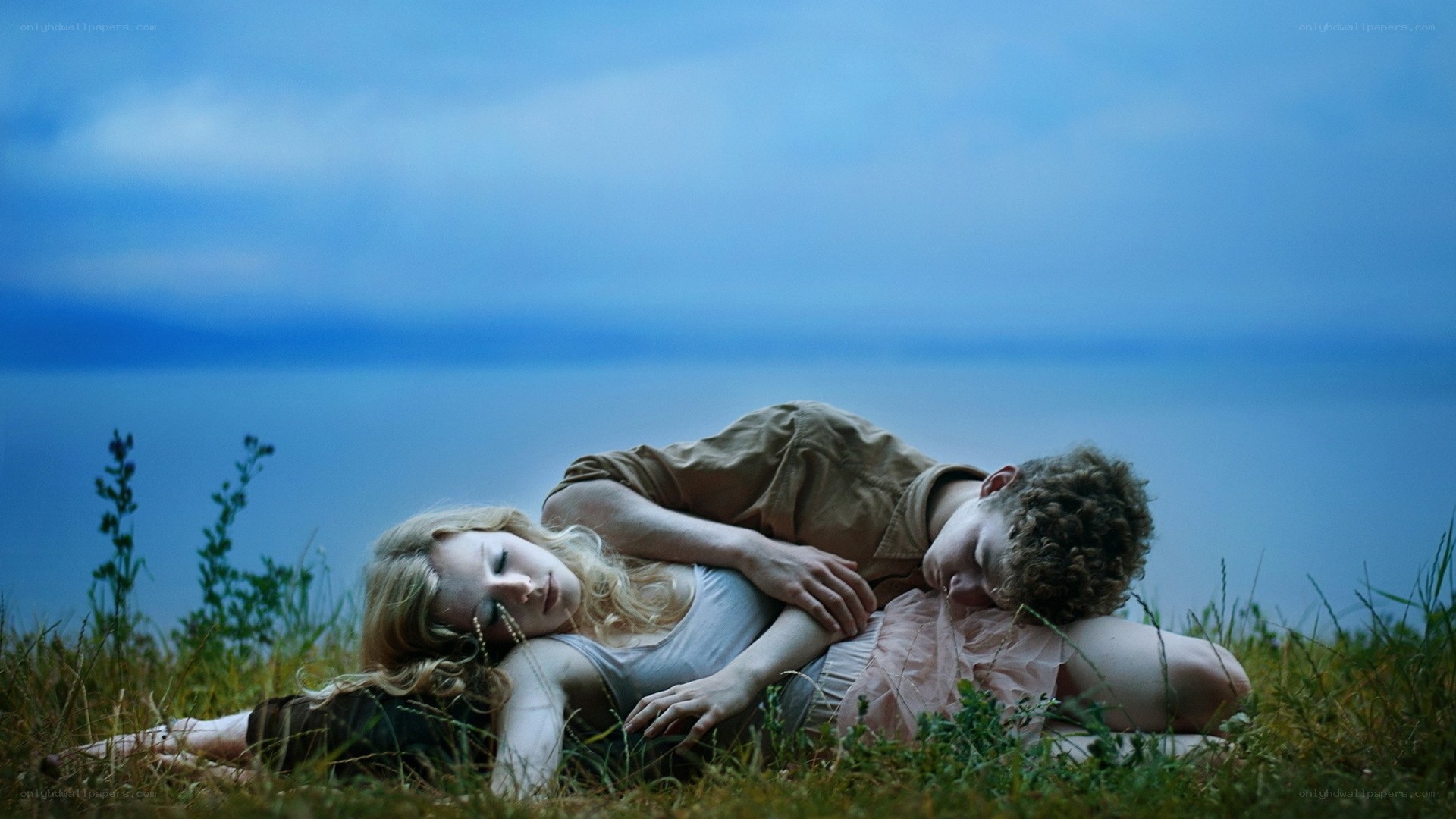 Couple resting on a hillside