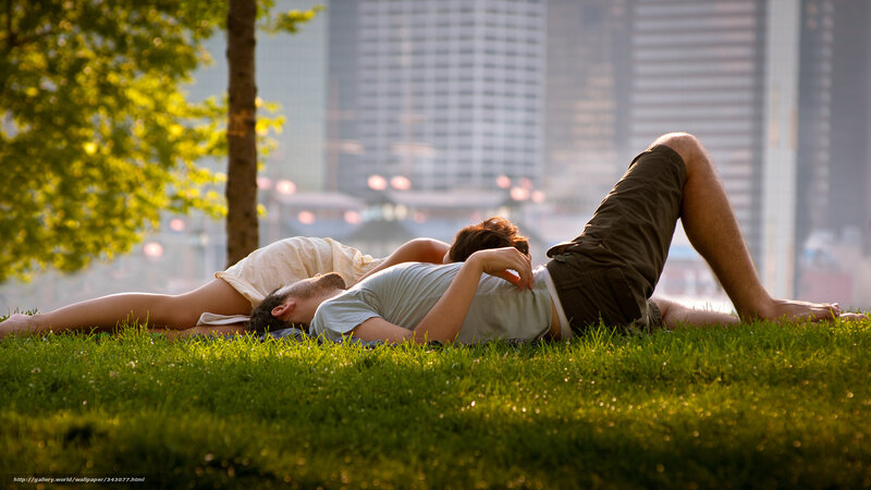 Couple resting on grass