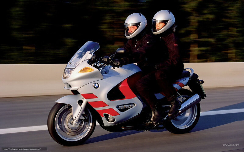 Couple riding a BMW motorcycle
