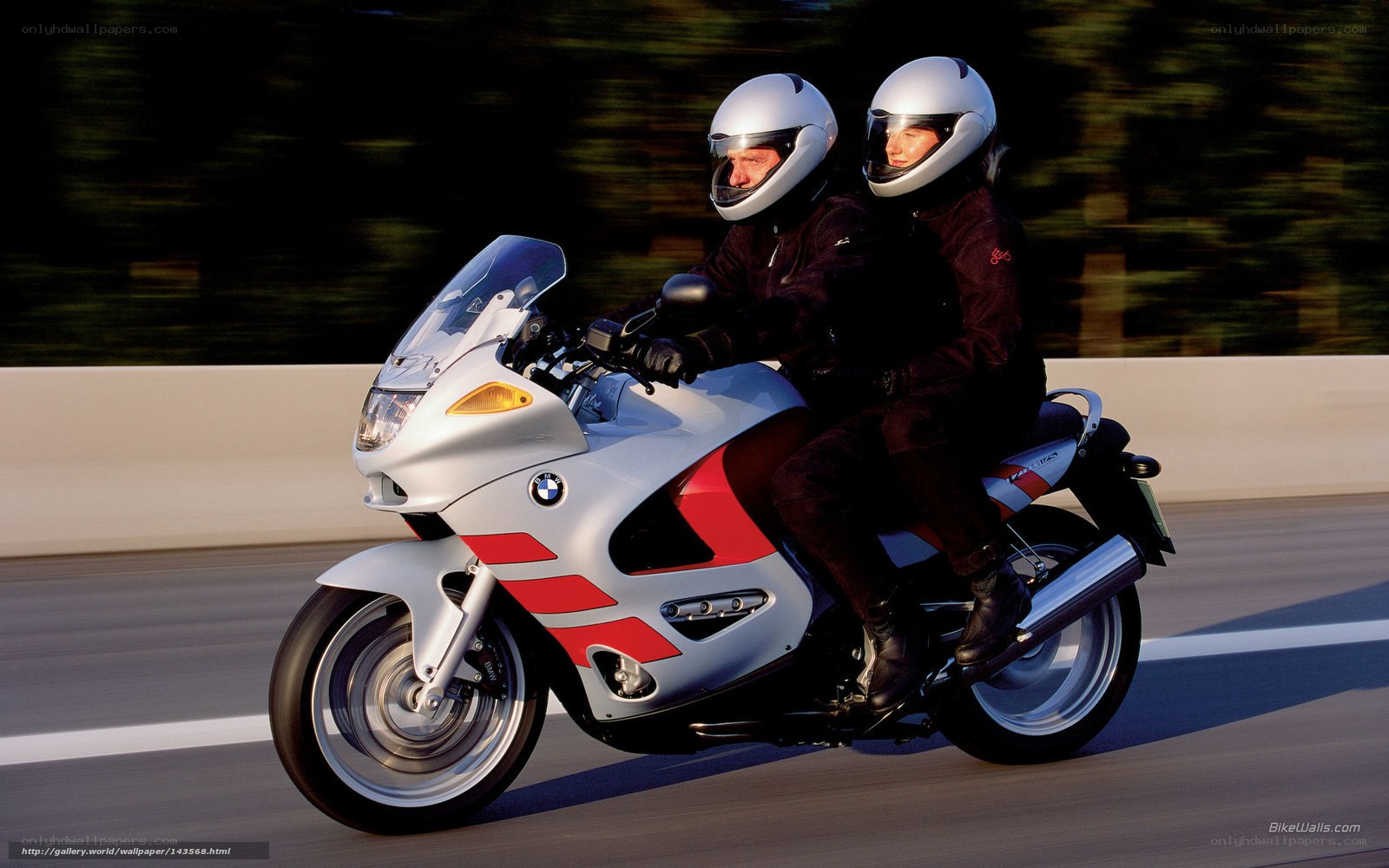 Couple riding a BMW motorcycle