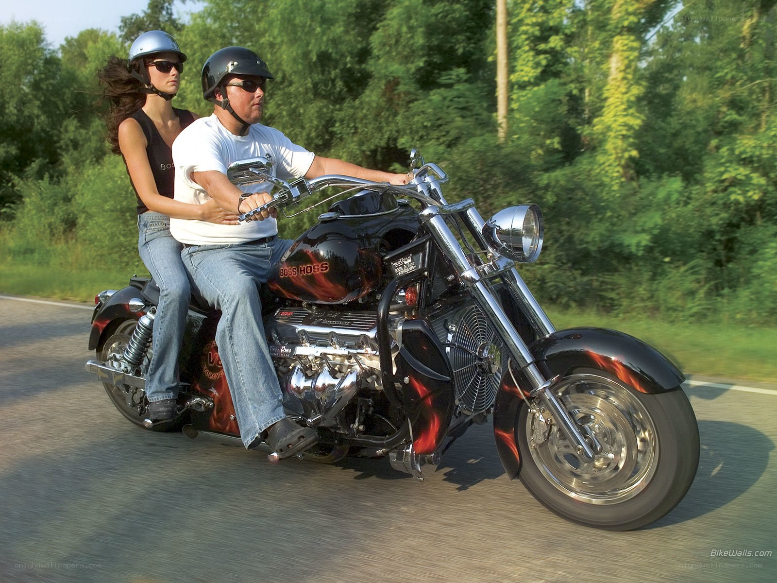 Couple riding a custom motorcycle