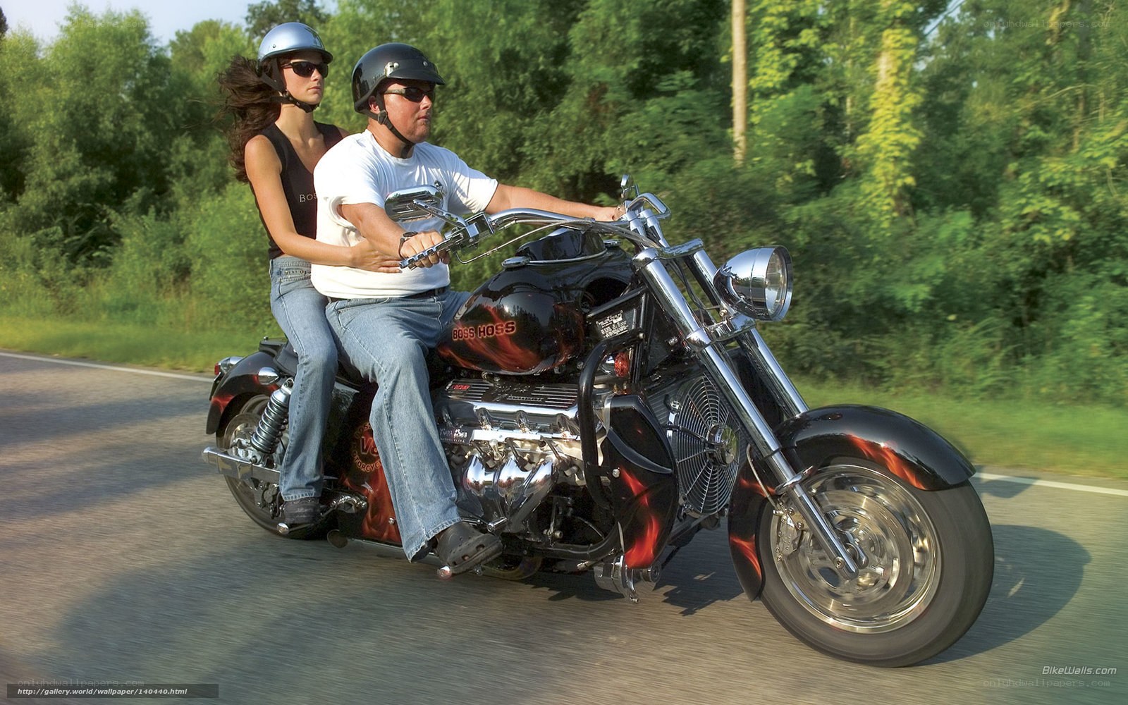 Couple riding a custom motorcycle