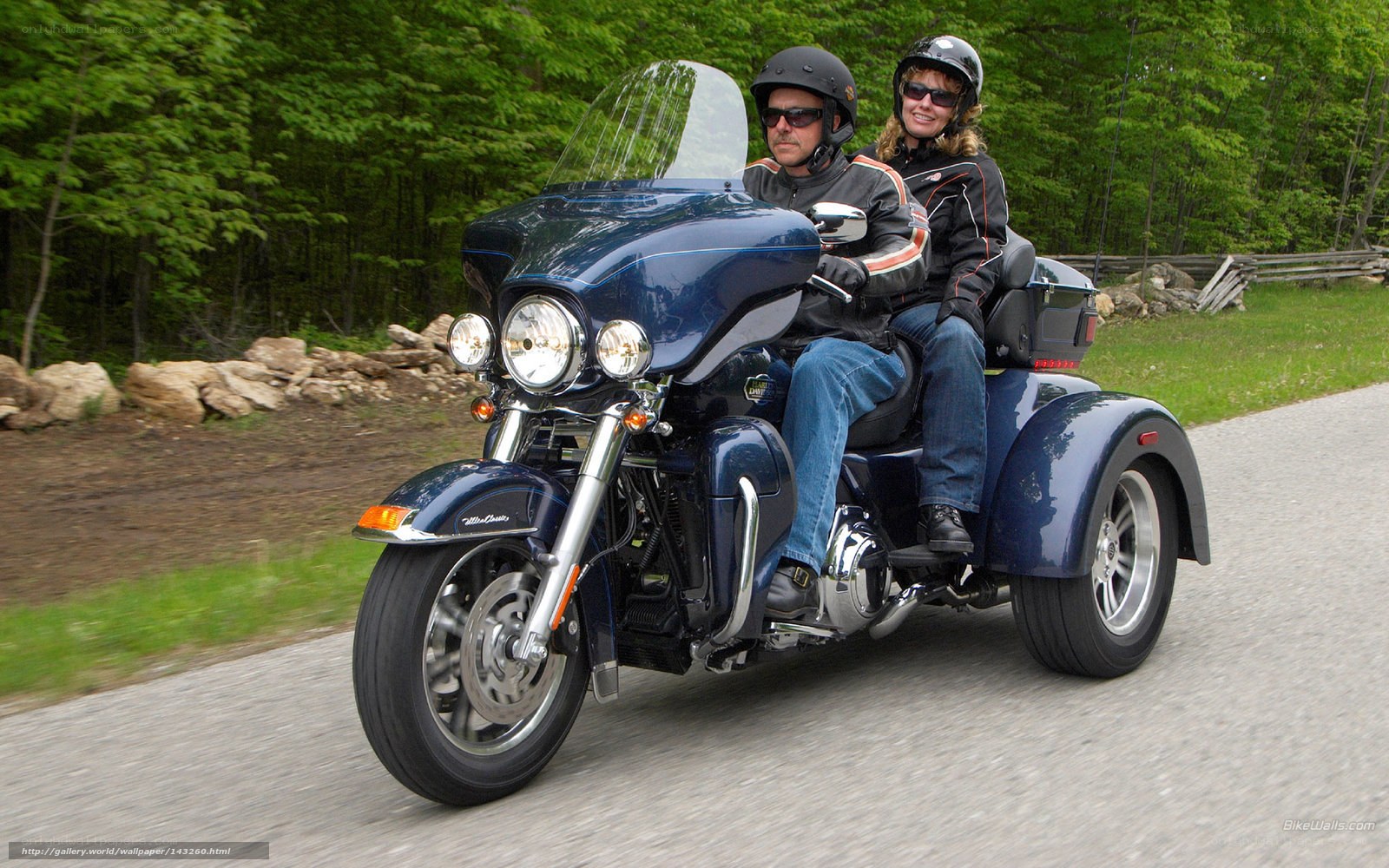 Couple riding a trike motorcycle