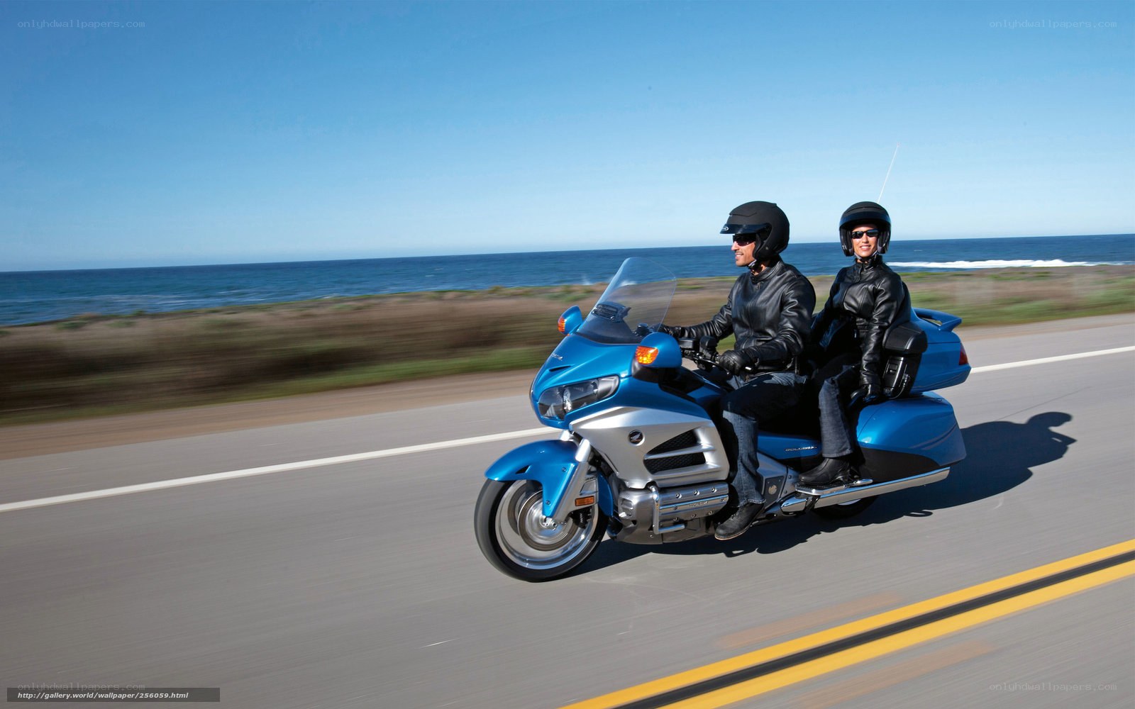 Couple riding blue motorcycle