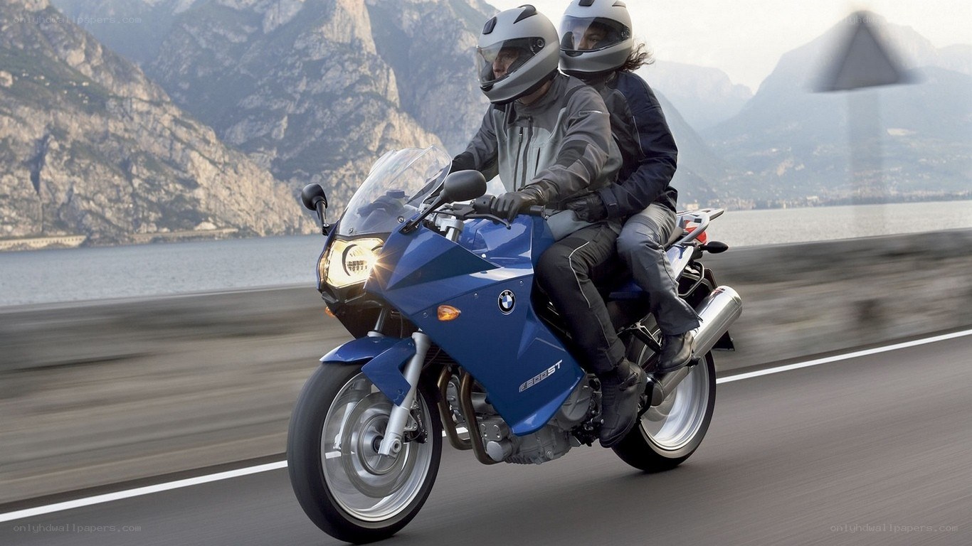 Couple riding blue motorcycle