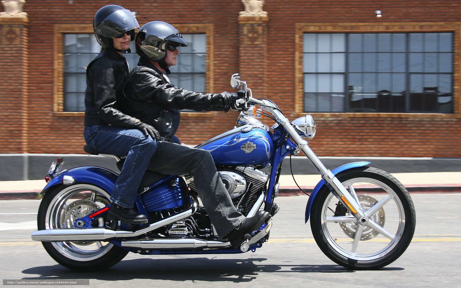 Couple riding blue motorcycle