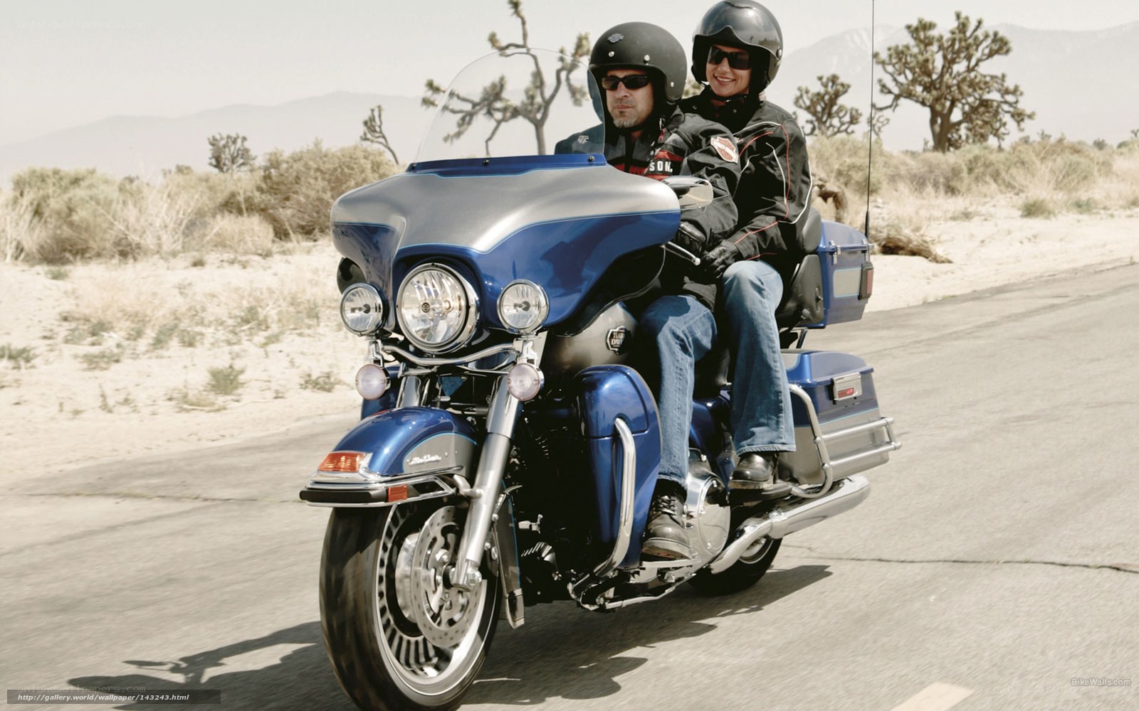 Couple riding blue motorcycle