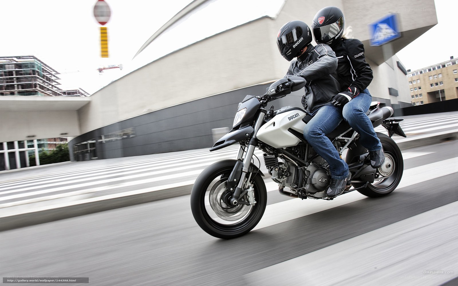 Couple riding Ducati motorcycle
