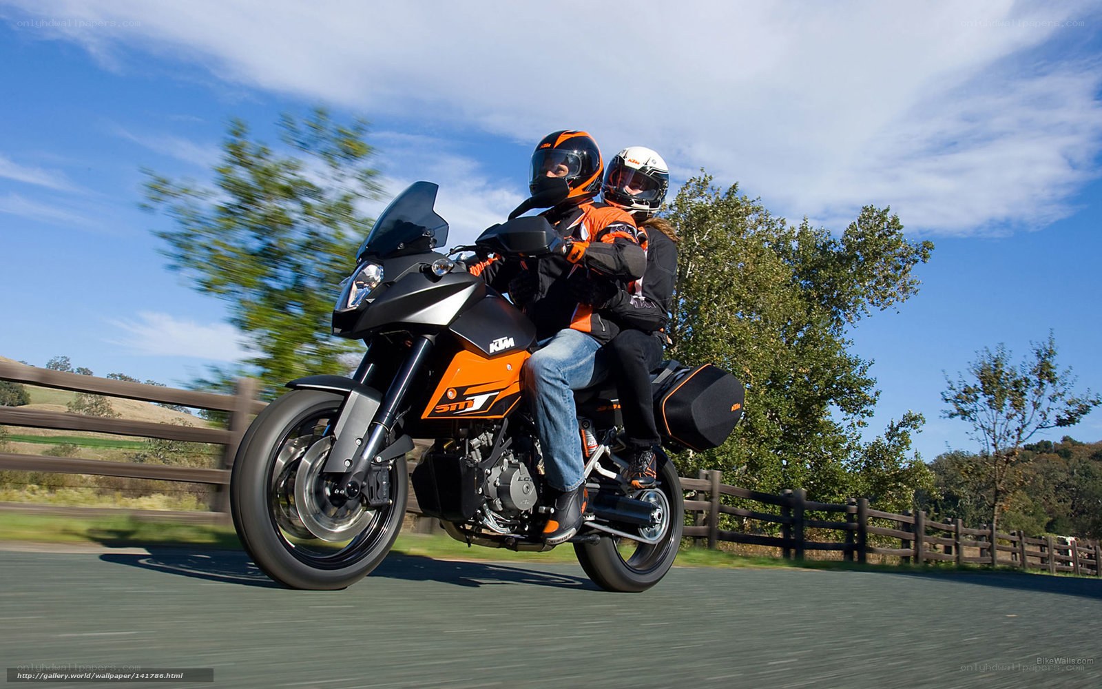 Couple riding KTM motorcycle