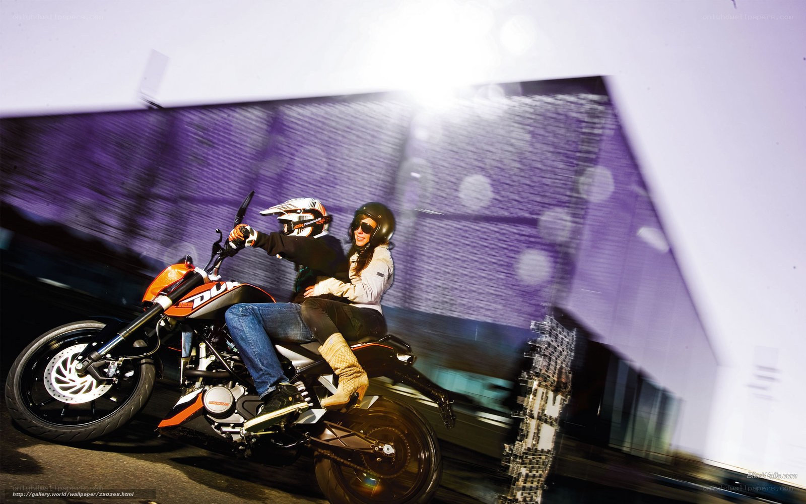 Couple riding motorcycle at night