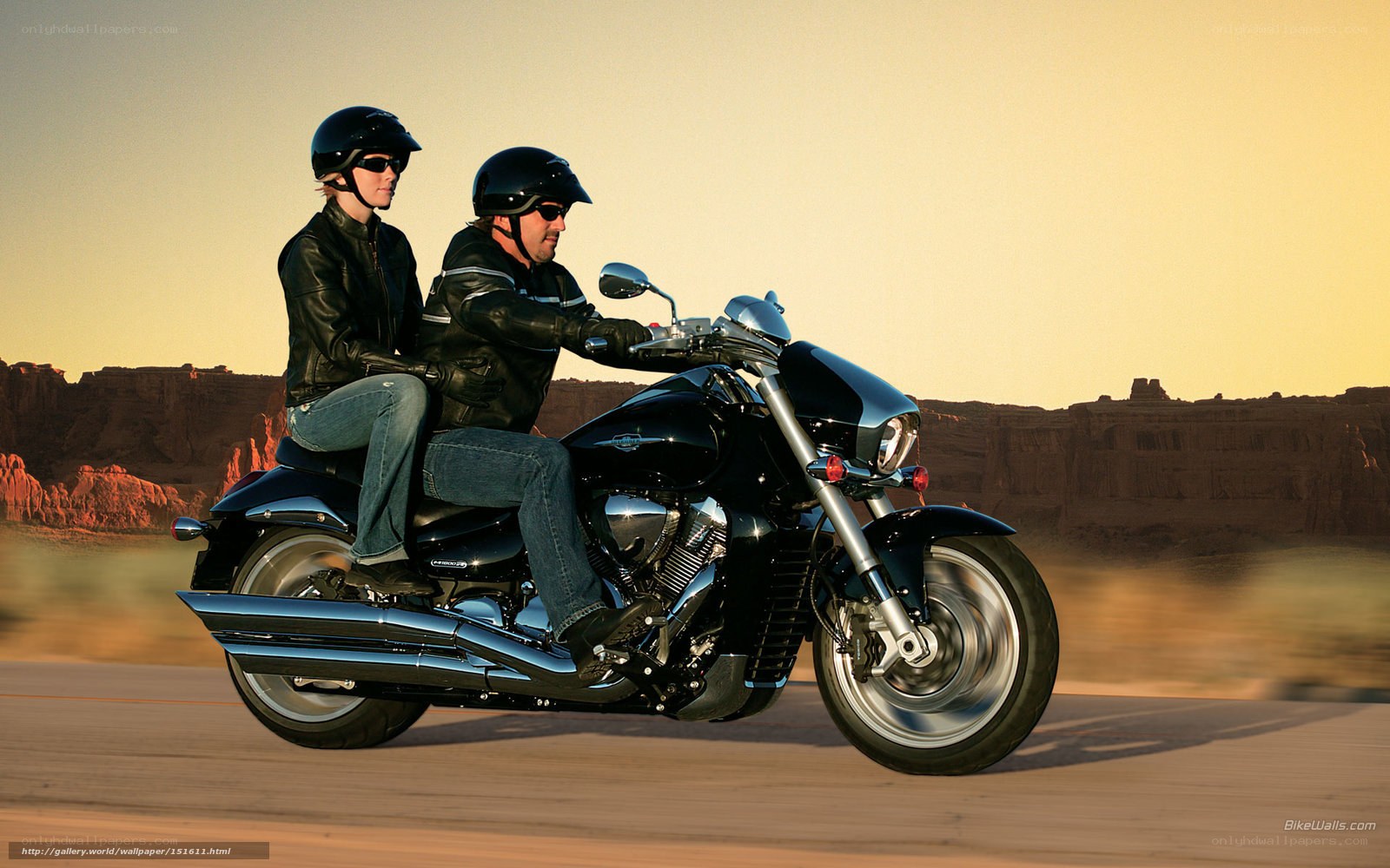 Couple riding motorcycle in desert