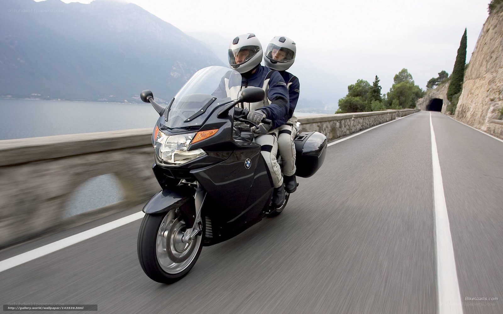 Couple riding motorcycle on coastal road