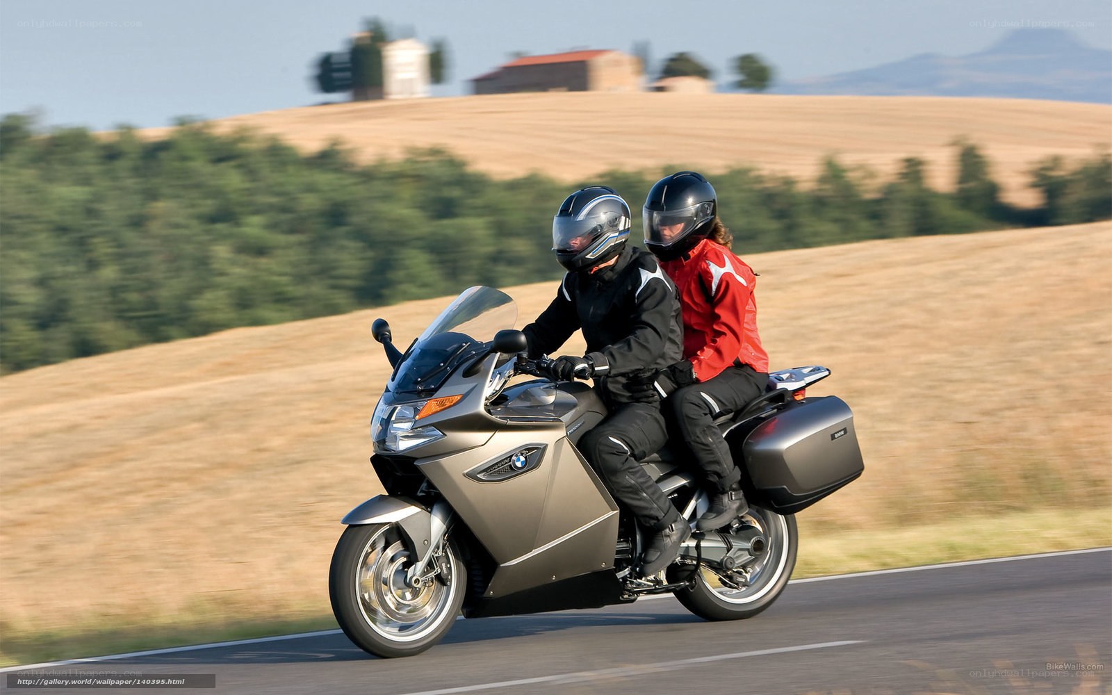 Couple riding motorcycle on country road