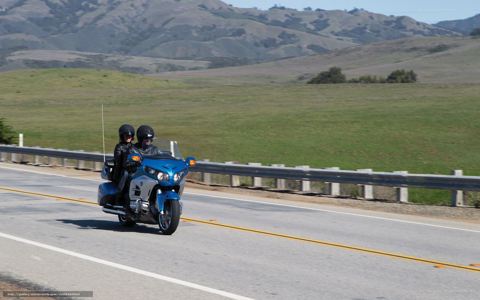 Couple riding motorcycle on highway