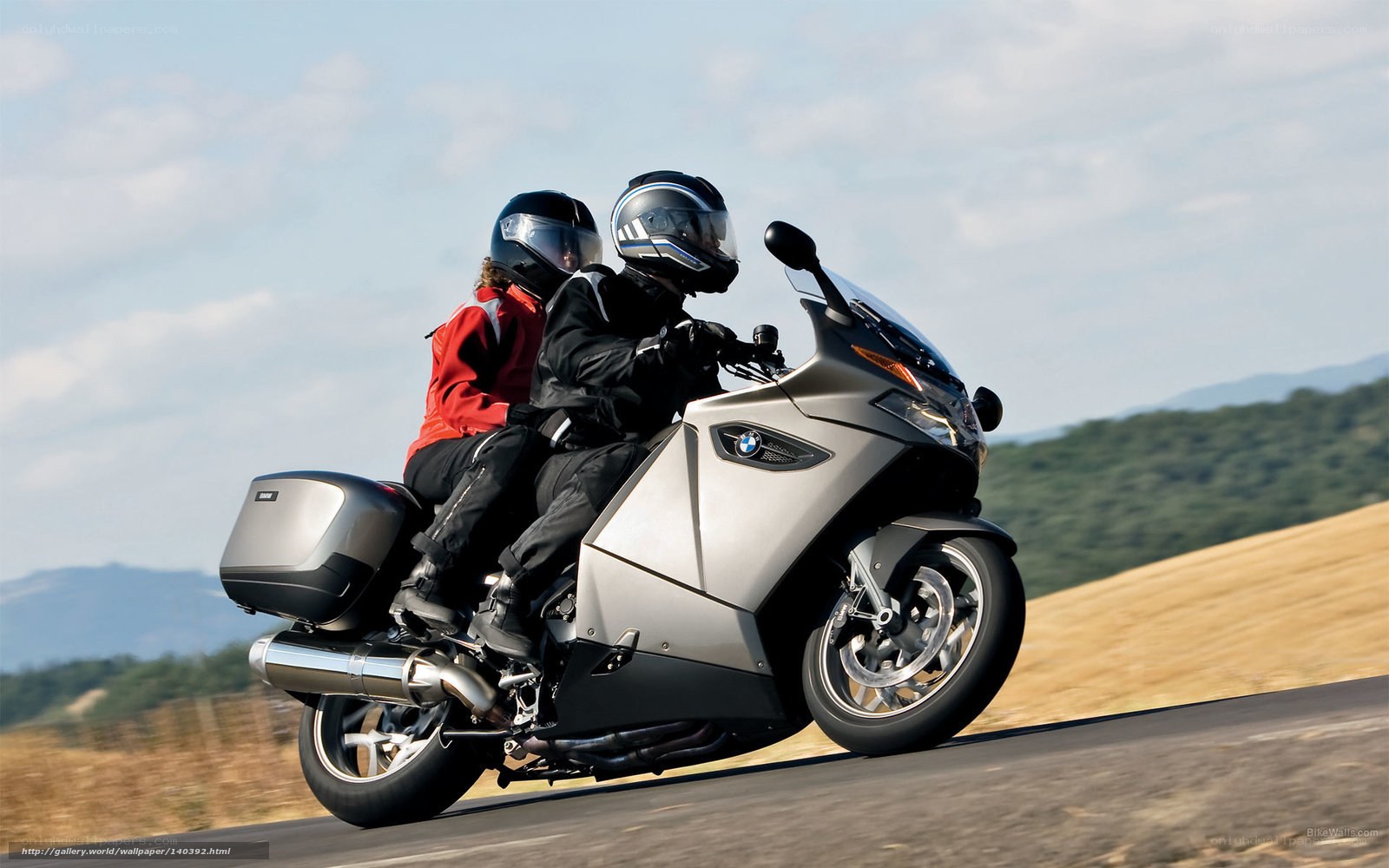 Couple riding motorcycle on road
